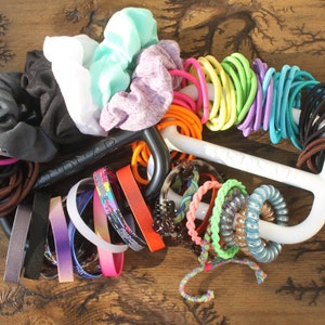 The BANDNAB Hair Tie, Scrunchie, and Banded Accessories Organizer Makes A Great Unique Gift for Anyone with Long Hair.