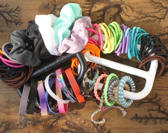 The BANDNAB hair tie, scrunchie, and banded accessories organizer makes a great unique gift for anyone with long hair.