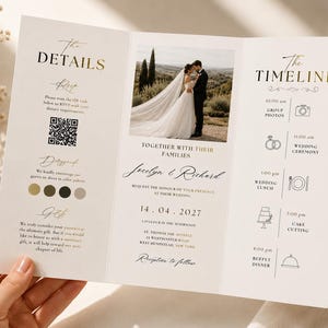 May include: A tri-fold wedding invitation card featuring gold and black text. The centre panel displays a photograph of a couple, names Jocelyn and Richard, and the date 14.04.2027. The left panel shows details and a QR code, while the right panel lists a timeline.