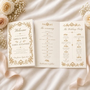 May include: A folded wedding programme printed on cream cardstock with gold-toned ornate floral borders. The front displays the names Amelia Rose and James Alexander, while the interior lists the ceremony order and the wedding party members.