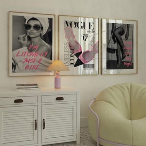 May include: Three framed art prints with gold frames. The left print features a black and white image of a woman with text that reads "I'M LITERALLY JUST A GIRL" in pink. The centre print is a Vogue magazine cover. The right print shows a woman's legs with text that reads "Every Night Is A Girl Night".