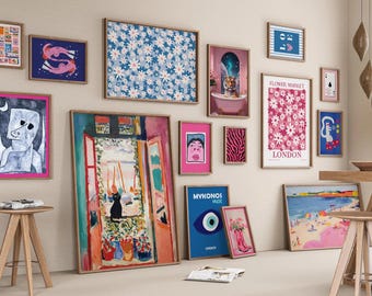 Pode incluir: Uma coleção de impressões de arte emolduradas em vários tamanhos e estilos, incluindo padrões florais, figuras abstratas e paisagens urbanas. A paleta de cores inclui azuis, rosas e tons terrosos. As impressões são exibidas em uma parede neutra.