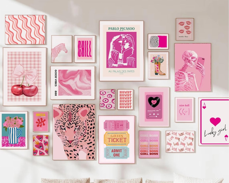 Gallery wall featuring a curated collection of diverse prints and artwork.  The pieces include floral patterns in pink and blue, a queen of hearts playing card, a cat in a window scene, an evil eye, and various abstract designs.  The color palette is vibrant, with pinks, blues, and greens dominating. The prints are framed in light wood and arranged in a visually appealing, eclectic style.  The overall theme is modern and playful.