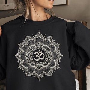 May include: Black sweatshirt with a white mandala design featuring the Om symbol.