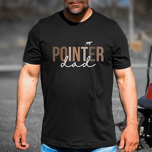 May include: Black t-shirt with the text "POINTER dad" in brown and white lettering. A small white silhouette of a dog is above the text.