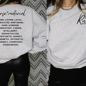 May include: Gray sweatshirt with the text "nurse material" and a list of positive qualities, such as kind, loving, loyal, dedicated, nurturing, hard-working, persistent, caring, intelligent, sophisticated, empathetic, honest, energetic, optimistic, friendly, competent, and courageous. The sweatshirt also has the text "Rn" with a heart and the name "Susan" on the front.