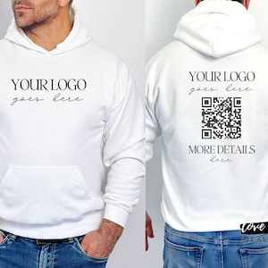 May include: White hoodie with a black text overlay that says "YOUR LOGO goes here" on the front and "YOUR LOGO goes here" and a black and white QR code with the text "MORE DETAILS here" on the back.