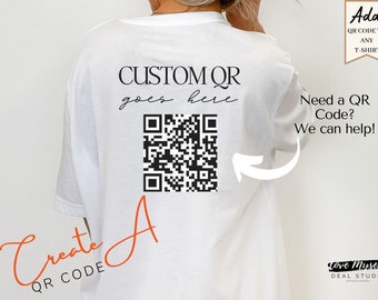 May include: A white t-shirt with a black and white QR code printed on the back. The text "CUSTOM QR goes here" is printed above the QR code. The text "Create A QR CODE" is printed in orange on the bottom left of the shirt. The text "Add QR CODE TO ANY T-SHIRT" is printed on a yellow tag on the top right of the image. The text "Need a QR Code? We can help!" is printed on the right side of the shirt. The text "Love Myselk DEAL STUDIO" is printed on the bottom right of the image.