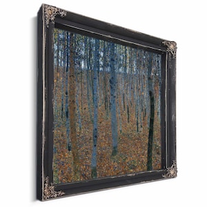 May include: A framed art print depicting a forest scene with tall, slender trees and a ground covered in autumn leaves. The artwork is enclosed in a black frame with ornate corner details, creating a classic aesthetic.