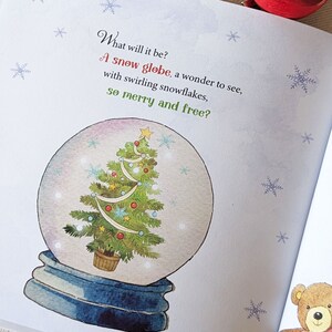 May include: A page from a children's book features a snow globe illustration. Inside the globe is a decorated Christmas tree. The text reads, "What will it be? A snow globe, a wonder to see, with swirling snowflakes, so merry and free?"