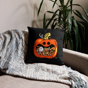 May include: Black cushion with a white and orange illustration of a pumpkin filled with sweets and a ghost. The pumpkin has a smiling face and a stem.