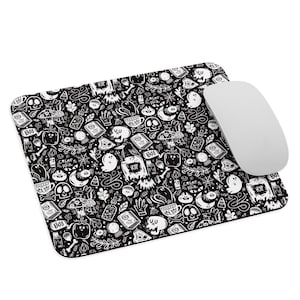 May include: Black and white mouse pad with a Halloween themed pattern. The pattern includes ghosts, skulls, pumpkins, and other spooky elements.