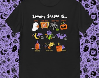 May include: Black t-shirt with the text "Spooky Season Is..." and Halloween-themed illustrations. The design includes ghosts, pumpkins, bats, and other spooky elements. A fun and festive graphic tee for the Halloween season.