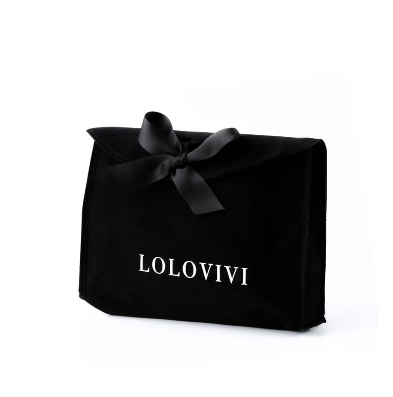 May include: A black velvet pouch with a black satin ribbon bow. The pouch has the white text "LOLOVIVI" printed on the front. The rectangular pouch is closed with a flap and is likely for storing items.