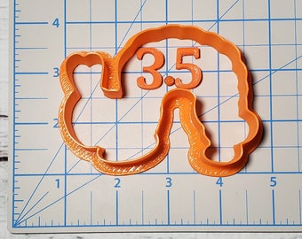 May include: Orange plastic cookie cutter shaped like a cartoon sheep with the number 3.5 inside.