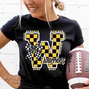 May include: Black t-shirt with a yellow and black checkered "W" with a yellow bow and the word "warriors" underneath. A brown football with white laces is in the lower right corner.