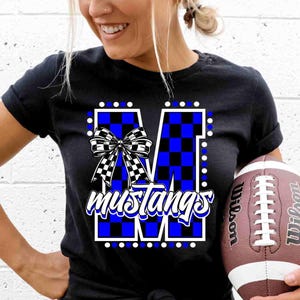 May include: Black t-shirt with a blue and white checkered "M" with a white bow and the word "mustangs" in white lettering.