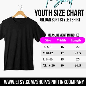 May include: Black Gildan Soft Style youth t-shirt hanging on a wooden hanger. The image includes a size chart with measurements in inches: S 6-8 (16" width, 22" length), M 10-12 (17" width, 23.5" length), L 14-16 (18" width, 25" length), XL 18-20 (19" width, 26.5" length).