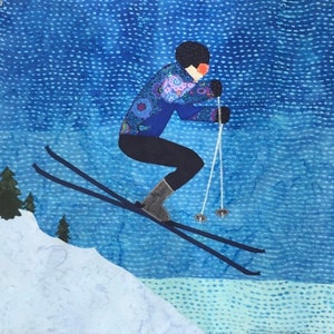 May include: A blue and purple patterned jacket with black trousers and brown boots. The person is skiing down a snowy slope with blue skies in the background.