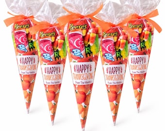May include: Five clear cone-shaped plastic bags filled with assorted candies, including Reese's and candy corn, tied with orange ribbons. Each bag features a white label with the text "HAPPY THANKSGIVING From The Medlin's" and a pumpkin print.