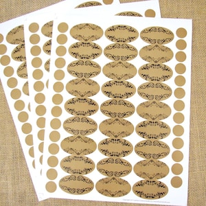 May include: Three sheets of brown kraft paper labels with a black and white design. The labels are oval shaped and have a space for writing. There are also round labels on the sheets.