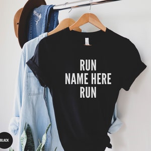 May include: Black t-shirt with white text that reads "RUN NAME HERE RUN".