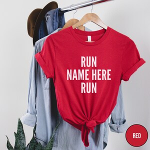 May include: Red t-shirt with the text "RUN NAME HERE RUN" in white.