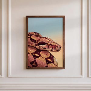 May include: A rectangular wall art print in a dark wood frame featuring a detailed illustration of a snake with brown and tan patterned scales. The snake is positioned against a gradient background that transitions from light blue to orange.