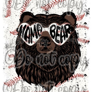 May include: A brown bear wearing heart-shaped sunglasses with the text "Mama Bear" on them. The bear is set against a white background with red baseball stitches.