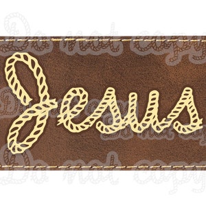 May include: A brown leather patch with a stitched border. The word "Jesus" is written in a rope-like font in a light yellow color.