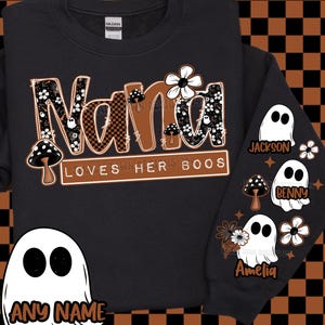 May include: Black sweatshirt with the text "Nana Loves Her Boos" in brown and black checkered letters, decorated with flowers and mushrooms. The sleeve features ghost graphics with names. A ghost graphic with the text "ANY NAME" is also visible.