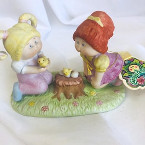 May include: A set of three ceramic mugs with a speckled, matte finish. The mugs are in shades of cream, light gray, and dark gray. Each mug has a simple, minimalist design, perfect for coffee or tea.