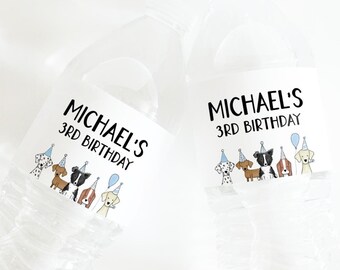 May include: Two clear plastic water bottles with labels that read "MICHAEL'S 3RD BIRTHDAY" in black text. The labels feature illustrations of dogs wearing party hats and holding balloons. The bottles are filled with clear liquid.