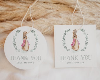May include: Two white thank you tags with a watercolor illustration of a brown rabbit wearing a pink jacket. The tags have a green wreath around the rabbit and the text "Thank You Love, Morgan".