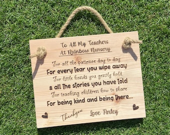 May include: A wooden sign with a message thanking teachers at Rainbow Nursery for their patience, care, and teaching. The sign is decorated with hearts and has a rope for hanging.