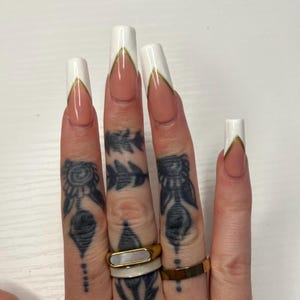 White French tip press on gel x nails with gold detail stripe