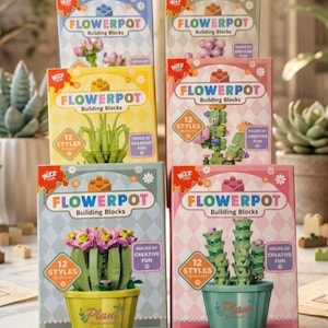 May include: Six boxes of "FLOWERPOT Building Blocks" are shown, each with a different plant design. The boxes display various flower and cactus arrangements, with the text "12 Styles" and "Hours of Creative Fun". The boxes are in shades of blue, green, yellow, and pink.