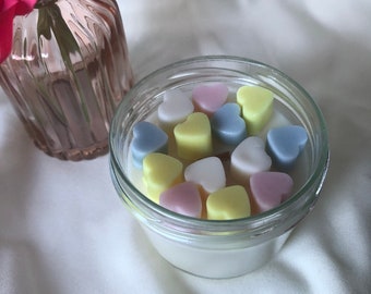 Homemade scented candle with multicolored hearts