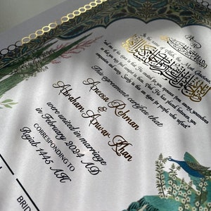 May include: A wedding certificate with gold lettering on a white background. The certificate states that Aneesa Rehman and Abraham Anwar Khan were united in marriage in February 2024 AD, corresponding to Rajab 1445 AH. The background features a colourful illustration of peacocks and flowers.