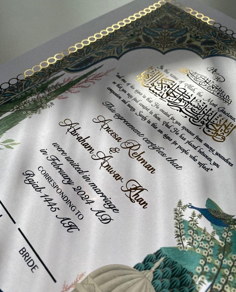 May include: A wedding certificate with gold lettering on a white background. The certificate states that Aneesa Rehman and Abraham Anwar Khan were united in marriage in February 2024 AD, corresponding to Rajab 1445 AH. The background features a colourful illustration of peacocks and flowers.