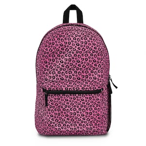 May include: Pink leopard print backpack with black straps and a zippered front pocket.