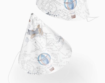 May include: Two white party hats with a map and airplane design. The hats have a blue and white hot air balloon, a blue airplane, and a white string.
