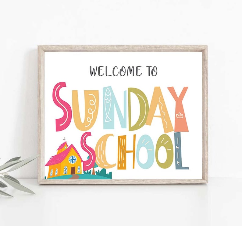 May include: A colorful sign with the text "Welcome to Sunday School" in a whimsical font. The sign features a small cartoon church building with a red roof and yellow walls.