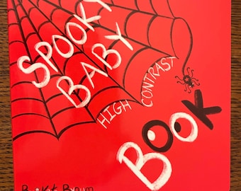 Może przedstawiać: Kwadratowa książeczka całokartonowa z jaskrawoczerwoną okładką i czarną ilustracją pajęczyny. Tekst brzmi "SPOOKY BABY HIGH CONTRAST BOOK" białymi i czarnymi literami, z małą grafiką pająka oraz napisem "By Kate Bynum" na dole.