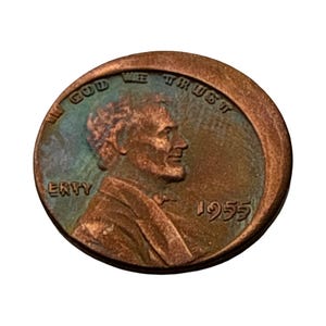 May include: A copper-colored United States one-cent coin featuring a profile of Abraham Lincoln facing right. The coin displays the text IN GOD WE TRUST along the top edge, the word ERTY on the left, and the year 1955 on the right side.