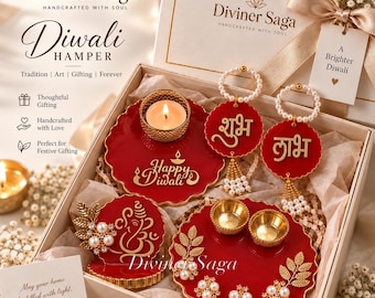 May include: A Diviner Saga Diwali gift hamper box containing red resin decorative items including a candle holder, two circular wall hangings with gold Hindi text, a Ganesha plaque, and a tray with two gold bowls and floral pearl accents.