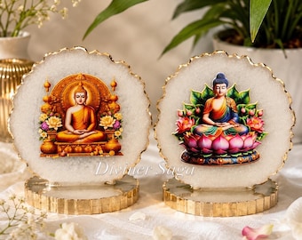 May include: Two decorative Buddha statues. Each statue features a seated Buddha image on a white, agate-like disc with a gold-colored edge. The bases are gold-colored with a textured design. The text "Diviner Saga" is visible on the bottom of the image.
