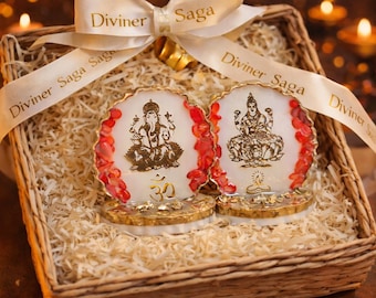 May include: Two white and gold religious figurines with red accents are presented in a woven basket with straw. A cream-colored ribbon with the text "Diviner Saga" is tied in a bow over the basket.