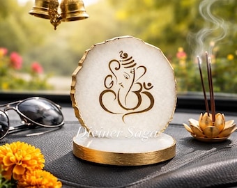 May include: A white and gold decorative piece with a brown illustration of a deity, with the text "Diviner Saga". Incense sticks are burning in a gold lotus flower holder. Sunglasses and orange flowers are also visible.