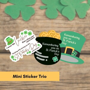 May include: Three mini stickers with a St. Patrick's Day theme. One sticker features a pot of gold with the text "Remembering you on St. Patrick's Day". Another sticker features a green hat with the text "Remembering you on St. Patrick's Day". The third sticker features a green shamrock with the text "I never felt luckier than when you were here. Thinking of & missing you this St. Patrick's Day and always."